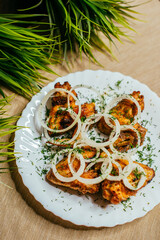 grilled wings with onions on a plate