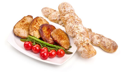 Roasted juicy pork steaks with asparagus, isolated on white background. High resolution image.