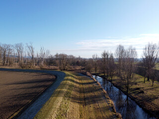 Fototapeta premium A brook river stream in Bavaria, aerial view photographed with a drone in winter