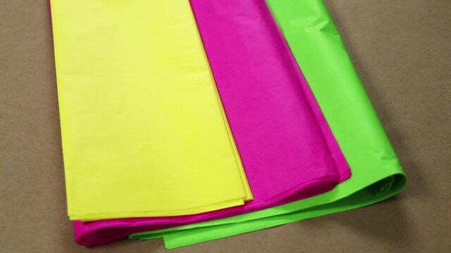 Tissue paper in bright colors: yellow, pink and green. Paper for crafts, pi&ntilde;atas and decorations.