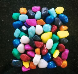 Colorful acquarium pebbles.Also using  for garden decoration.Commonly available in diffrent shapes and colors.