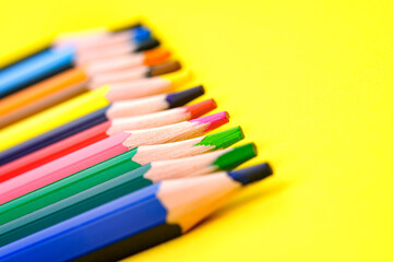 Background, blur, out of focus, bokeh. Colored pencils isolated on a yellow background. The concept of creativity development.