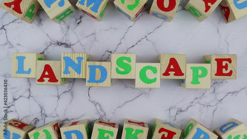 Poster landscape concept with colorful alphabet letters on wooden cubes centered between top and bottom bor