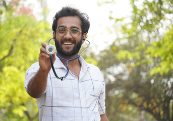 A exited student showing stethoscope- college student with stethoscope and showing success sign- Medical Education concept