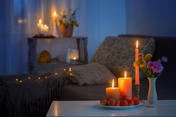 autumn decorations with burning candles at home