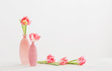 tulips in pink vase on white table