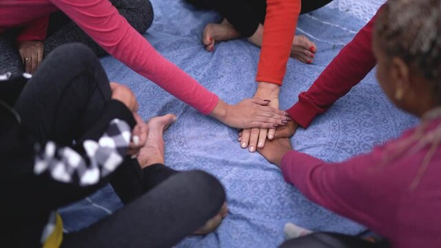 Top view of stracking hands of multiracial women - Multi generational people 