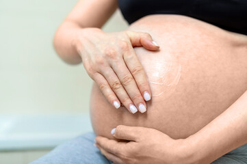 Fototapeta na wymiar Pregnant woman holding belly