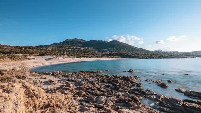 Time-lapse video of Mediterranean sea washing onto the sandy beach at Bodri in the Balagne region of Corsica under a blue sky