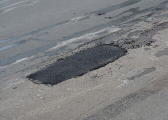 Pothole asphalt patching, asphalt road crack pothole repair, driveway, pavement patching repair.