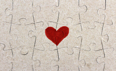 The heart on the assembled puzzle pieces. Half one whole