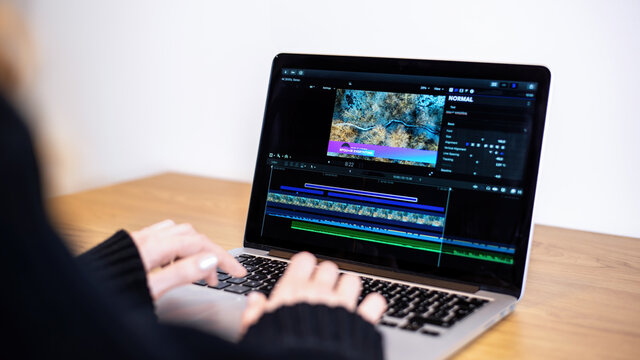 Young content creator girl editing video on her laptop