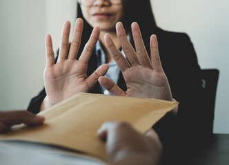 Government officials raise the hand refusing money to take the bribe money from business man the...
