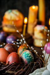 Beautiful Easter cake, candles, willow branches and painted eggs as a symbol of Easter