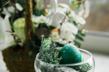 Beautiful green Easter eggs in an Easter composition, a modern symbol