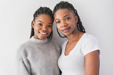 mother and her teenage daughter on white - obrazy, fototapety, plakaty