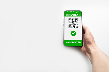 Vaccinated person using digital health passport application on mobile phone to travel during the COVID-19 pandemic