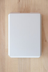 External hard drive 2.5 inches in a silver aluminum casing. Modern data storage devices.