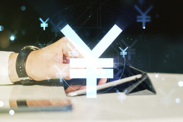 Double exposure of creative Japanese Yen symbol hologram and finger clicks on a digital tablet on background. Banking and investing concept