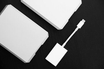External storage media. Modern usb-c connectors. Two external hard drives in silver and a white card reader with a usb-c connector. Storage, copying and backup of data for photographers, videographer