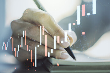 Multi exposure of abstract financial diagram with hand writing in notepad on background, banking and accounting concept