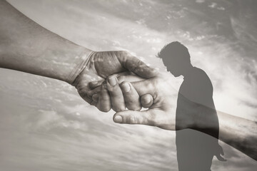 Sad and depressed man in need of help and support. Giving a helping hand and salvation concept. 