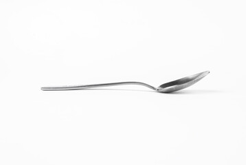Tea spoon on a white background. Side view of a teaspoon. Dessert spoon.
