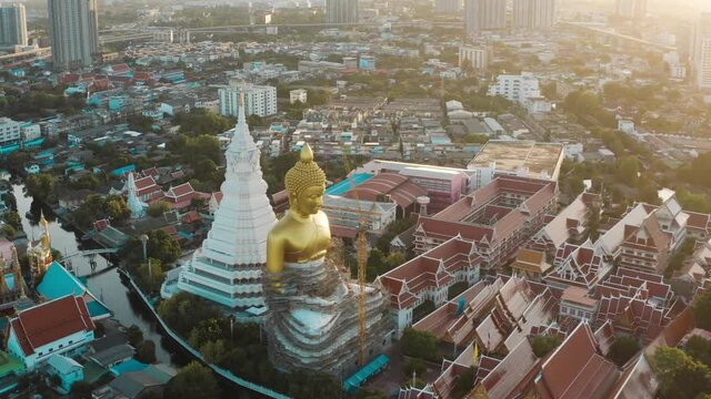 Aerial view of Wat Paknam Bhasicharoen, a temple, pagoda and Buddha statue in Bangkok Thailand. High quality 4k footage