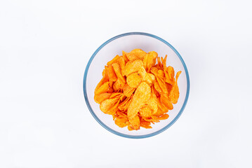 Chips in a bowl. Top view of grooved chips in a bowl. Chips in a mesh bowl on a white background.