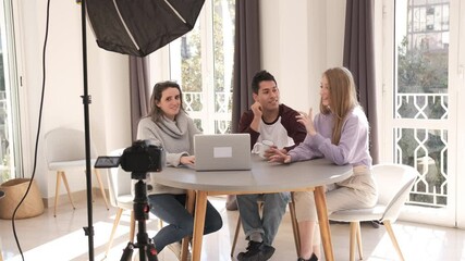 A group of people creating content for social media while making a video.