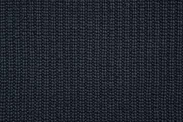 abstract background of black knit fabric texture close up
