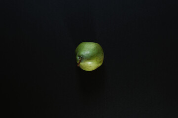 Top view of a green pear isolated on a black background