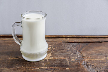a mug of milk on an old wooden table