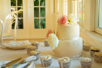 Wedding cake on table in restaurant decorated with flowers