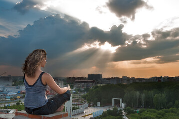 Fototapeta na wymiar Attractive girl meditating at sunbeam