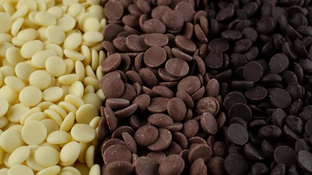 chocolate chips from white, milk, black chocolate top view. assorted chocolate. confectionery concept