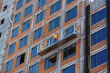 Suspended platform or cradle for construction, installation and repair work of building facades of skyscrapers.