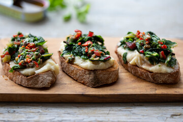Crostini with white bean and potato puree and Swiss chard