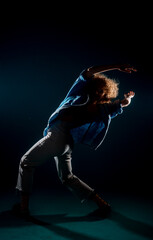 Fototapeta na wymiar Choreographic dance in dark studio