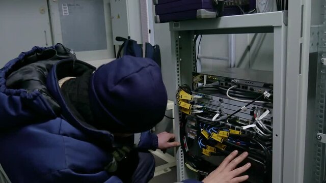 Technicians are installing optic fiber with cable ties.