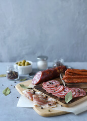 Sliced meat. Various types of meat, olives and spices. Vertical photo. Selective Focus
