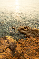 Landscape of Cap de Creus, a natural reserve in Costa Brava, Spain. Seashore with cliffs and warms sunset or sunrise light. 
