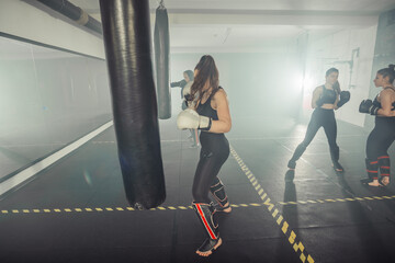 Boxer woman. Boxing fitness woman smiling happy wearing black boxing gloves. Portrait of sporty fit Asian model of boxing gym