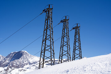 Three towers with cables delivering electric energy supply for alpine cable cars an Gornergrat...