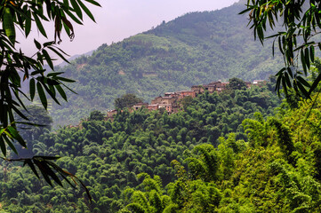 Rural village atop a hill in the mid of lush tropical forest