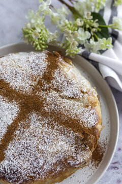 From above of appetizing bastilla with aromatic spices on table near flower sprig during Ramadan holidays