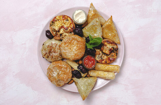 High angle of assorted tasty Arabic food with salsa and fresh mint leaves near almonds during Ramadan holidays