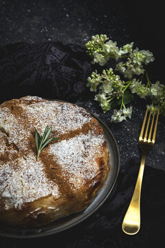 From above of appetizing bastilla with aromatic spices on table near flower sprig during Ramadan holidays