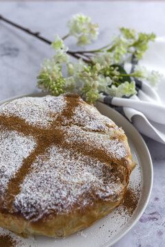 From above of appetizing bastilla with aromatic spices on table near flower sprig during Ramadan holidays