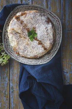 Top view of appetizing bastilla with aromatic spices on table near flower sprig during Ramadan holidays